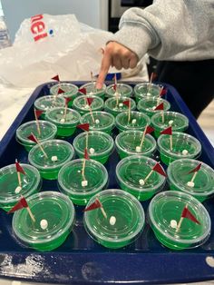 several cups with toothpicks sticking out of them on a tray in the kitchen