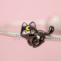 This is charm only, bracelet is sold separately. This cute Luna cat charm features a black cat design with a gold moon on forehead, made of solid 925 sterling silver with black gold metallic plated. Add this cute lunar cat bead charm to your existing charm bracelet or as gift for your love one. Add a touch of whimsy and mystery to your charm bracelet with the Lunar black cat charm! Crafted with high-quality sterling silver and adorned with a stunning gold moon, this unique and stylish charm is p Cute Black Jewelry With Charms, Black Sterling Silver Charm Bracelet As Gift, Black Jewelry With Removable Charms For Gifts, Cat Bead, Cat Charm, Silver Charm Bracelet, Gold Moon, Cat Design, Sterling Silver Charm