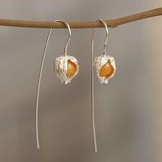 "The perfect gift for nature lovers♥ Made from topaz and great for everyday wear, these golden berry earrings are your best shot at looking chic and classy on a budget. There is no need to reach for the gaudy and everyday accessory you go for. Change your looks and entire appearance by just reaching for this pair of simple yet elegant earrings. Whether it is a meeting with the boss or a casual night out with the girls or a fun evening out all by yourself, these pair have got you covered. It is i Handmade Apricot Earrings Perfect For Gifts, Bohemian Apricot Jewelry For Gift, Handmade Apricot Earrings For Gift, Apricot Drop Earrings For Gifts, Unique Amber Earrings Gift, Elegant Pierced Amber Earrings, Elegant Orange Sterling Silver Earrings, Golden Berry, Ground Cherry