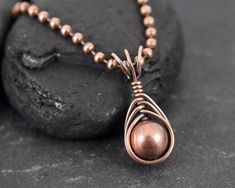 This pendant was made with copper wire, copper beads, copper chain and a copper bead.  Measurements Pendant width: 10 Millimetres; Pendant height: 23 Millimetres; Necklace length: 47 Centimetres ✩ The item comes in a branded gift box- perfect for gifting.  ✩ All items are handcrafted by myself and every effort is taken to produce a high quality product.  ✩ Copper and sterling silver jewellery care: copper and sterling silver pieces will tarnish over time. To restore the shine simply polish the piece using a jewellery polishing cloth.  ✩ If you have any questions, send me a message! I am also doing jewelry upon request, so if you have an idea of what you'd like me to make for you, please get in touch to talk about it! Copper Beaded Chain Jewelry Gift, Copper Beaded Chain Jewelry As Gift, Copper Beaded Chain Jewelry For Gifts, Copper Necklaces With Round Beads For Gift, Rose Gold Copper Wire Wrapped Necklaces, Antique Copper Jewelry, Diy Pendants, Jewellery Diy, Wire Wrap Jewelry Designs