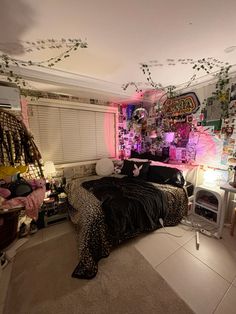 a bedroom decorated in pink and black with lots of decorations on the walls, flooring and bedding