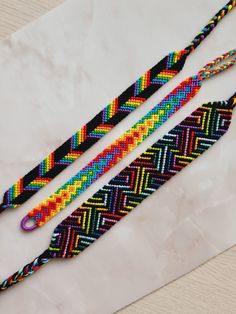 two colorful braided ties sitting on top of a table