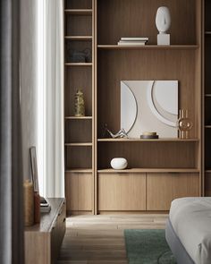 a bed sitting next to a wooden book shelf filled with books on top of a hard wood floor