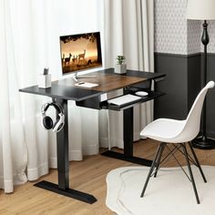 a desk with a computer on it and a chair in front of the monitor screen