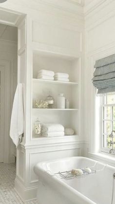 a white bath tub sitting next to a window