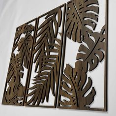 three wooden cut outs with leaves on them