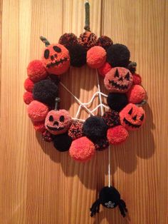 a halloween wreath made out of pom - poms