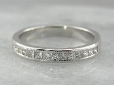 a white gold wedding band with princess cut diamonds