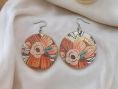 These beautiful orange floral earrings are perfect for any occasion! They are lightweight and easy to wear. They can also make a great gift! Wood base size: 2in diameter Wood finish: Diamond Glaze **NOTE** Each earring is handmade and may have a few blemishes to the finished product which may include tiny bubbles from the diamond glaze. Can be hard sometimes to get all the bubbles out, but they still look great. Also colors may slightly look different from photos due to lighting exposure or from Orange Drop Earrings For Spring, Orange Flower Earrings For Spring, Orange Earrings For Spring Gift, Spring Gift Orange Earrings, Orange Flower Shaped Earrings For Summer, Orange Flower-shaped Earrings For Summer, Round Flower Earrings As A Summer Gift, Orange Round Earrings For Summer, Bohemian Orange Earrings For Spring