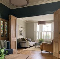 a living room filled with furniture and lots of windows