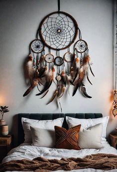 a bed with a dream catcher on the wall above it