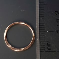 CECILE STEWART JEWELRY - septum ring / piercing ring / cartilage ring -OUTER diameter not inner diameter - select rose gf, yellow gf, sterling, or grey niobium - slightly thicker than standard ear hook wire -18 gauge wire is used - this is equal to 1mm - choose size 7 mm to 14mm -these are hammered and slightly wider on the lower edge -hammering is on one side only, it is not possible to do both sides -NICKEL FREE These are sold INDIVIDUALLY and not by the pair My catchless endless rings are han Nickel Free Hoop Septum Ring For Everyday Wear, Nickel-free Hoop Septum Ring For Everyday, Nickel-free Hoop Septum Ring, Hypoallergenic Rose Gold Hoop Septum Ring, Adjustable Rose Gold Hoop Septum Ring, Internally Threaded Rose Gold Hoop Nose Ring, Adjustable Hoop Septum Ring, Stackable, Adjustable Hoop Septum Ring, Stackable Hoop Septum Ring As Gift