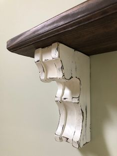 a close up of a wooden shelf with white paint on it's edges and wood trim