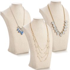 three necklaces on mannequins, one with blue beads and the other with gold chains