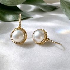 These simple and classic pearl drop earrings are perfect for everyday! Earrings feature beautiful mabè pearls set into a hammered bezel setting accented by dots. Process: Casting, Fabrication Materials: Solid 18K Yellow Gold, 11.3mm Fine Japanese Mabè Pearls with Mother of Pearl backing Size: 9/16" diameter Ships within 3-5 business days. Pretty Packages for Pretty Things Each piece ships in my custom packaging that is perfect for gift giving and safe keeping. Returns & Exchanges If for some reason a return or exchange is necessary, you have 7 days from the day you receive your package. Visit my policies page for more information. Classic Pearl Earrings, Jewelry Aesthetic, Mabe Pearl, Pearl Set, Everyday Earrings, Contemporary Jewelry, Custom Packaging, Pearl Size, Pearl Drop Earrings