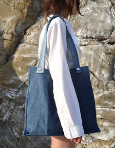 The Lam tote bag is perfect for everyday wear in a generously cut rectangular design large enough to carry a laptop and all of life's essentials.Details: Fibre content: 100% cotton Fabric source: Repurposed vintage denim (wash/seams may vary slightly) External seams Reinforced base White '1800' rivet buttons Lined in a cobalt cotton Inside slip pocket Machine wash cold | Gentle cycle Dimensions: Length 38cm, Width 41cm, Depth 12cm, Strap drop 30cm Luxury Cotton Bags With Pockets, Luxury Tote Bag For Everyday Carry, Luxury Rectangular Bag For Everyday Carry, Luxury Cotton Rectangular Bag, Luxury High-end Tote Bag, Luxury Bags With Fabric Lining For Everyday Use, Luxury Rectangular Bag With Fabric Lining, Everyday Rectangular Laptop Bag, High End Handbags