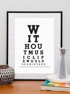 an eye chart print on a table next to a vase