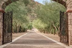 an open gate leading to a dirt road