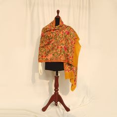 Mustard high-quality embroidered Kashmiri pashmina kashmiri wool shawl embellished with Kashmiri aari multicolored embroidery all over the piece. Perfect for formal occasions to add a pop of color to your outfits. These medium-length shawls are the perfect length to be styled with both eastern and western outfits. Dazzle up your wardrobe with a uniquely crafted fully embroidery shawl. Product specifications: Base color: Mustard Material: 100% Pashmina wool Washing instructions: Hand wash in cold water Dimensions:200cm by 70cm Shipping details: The product will be delivered to you between 5-10 working days. 1-2 days processing time for all orders. Now offering free shipping to your doorstep! Embroidered Pashmina Shawl For Transitional Seasons, Festive Embroidered Pashmina Fabric With Dupatta, Semi-stitched Pashmina Embroidered Dupatta, Bollywood Style Jamawar Dupatta With Naqshi Detail, Bollywood Style Jamawar Dupatta With Naqshi, Multicolor Pashmina Shawl With Chikankari Embroidery, Multicolor Embroidered Pashmina Shawl, Pashmina Shawl With Multicolor Embroidery In Traditional Drape, Multicolor Pashmina Shawl With Resham Embroidery