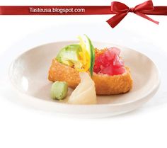 a white plate topped with different types of food on top of a red and white ribbon