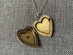 This vintage sweetheart necklace bears a US Navy insignia on a heart-shaped locket. The locket is hallmarked 10K gold-filled sterling from D'Aguanno Bros. The chain is a new, 14K gold-filled, and measures 18 inches. This piece has been restored as close as possible to its original condition, cleaned gently by hand with steam, polishing cloths, and good old-fashioned elbow grease.This vintage item has been loved and cherished by a previous owner, there will be some slight wear or imperfections. I Brass Heart Pendant Jewelry For Anniversary, Heirloom Hallmarked Locket Necklace For Anniversary, Vintage Charm Yellow Gold Heart Pendant Jewelry, Victorian Jewelry With Heart Pendant And Charm, Vintage Charm Heart Pendant Jewelry For Keepsake, Antique Heart-shaped Yellow Gold Jewelry, Victorian Heart Charm Pendant Jewelry, Victorian Jewelry With Heart Charm For Anniversary, Vintage Heart Pendant Charm Jewelry For Keepsake