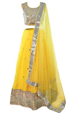 The skirt is is paired with a matching blouse and net dupatta and yellow lehenga! Navratri Wedding Skirt With Mirror Work, Wedding Skirt With Mirror Work For Navratri, Festive Yellow Saree With Mirror Work, Designer Yellow Saree With Mirror Work, Yellow Floor-length Anarkali Set With Mirror Work, Yellow Choli With Gota Work For Diwali, Designer Yellow Choli With Gota Work, Yellow Saree Set With Mirror Work, Yellow Anarkali Set With Mirror Work