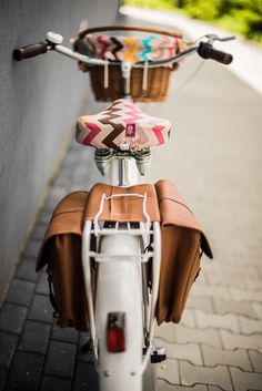 the back end of a bicycle with a basket on it's handlebars