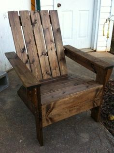 a wooden chair sitting on top of a sidewalk