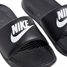 Nike Casual Synthetic Flip Flops, Nike Casual Slide Flip Flops, Nike Black Slide Sandals, Black Slip-on Flip Flops For Leisure, Black Slip-on Sandals For Leisure, Black Cushioned Sandals For Leisure, Black Leisure Sandals With Cushioned Footbed, Black Sandals For Spring Leisure, Nike Casual Synthetic Slippers