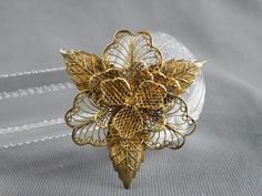 "This is a great filigree flower pin, sterling silver with gold plating aka vermeil. It is in very good vintage preowned condition with some oxidation and is 2\" tall by 1-7/8\" wide. All measurements are approximate. Please refer to the photos as they are an integral part of the description. Be sure to contact me with questions prior to purchasing.  Due to differences in screen settings, colors may differ slightly between photos and the physical product." Collectible Gold Filigree Brooches, Gold Filigree Brooches Collectible, Gold Filigree Brooches For Collectors, Ornate Gold Brooches For Jewelry Making, Gold Filigree Brooches As Gifts, Traditional Gold Brooch For Anniversary, Traditional Gold Brooches For Anniversary, Victorian Gold Brooch For Wedding, Victorian Gold Wedding Brooch