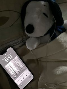 a stuffed animal with headphones laying next to an mp3 player