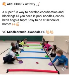 some kids are sitting on the floor and playing with plastic balls in an indoor gym