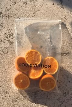 oranges in a clear plastic bag with louis vuitton written on the side