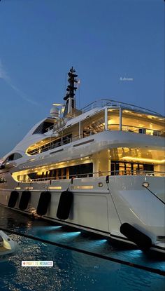 a large white boat in the water at night