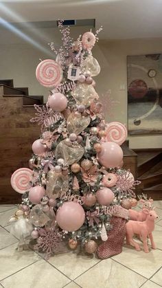 a christmas tree decorated with pink and silver ornaments