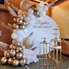 a birthday party with balloons and decorations on the floor in front of a large sign