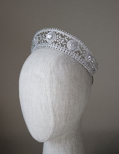 a white headpiece on a mannequin's head wearing a tiara