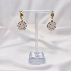 "This listing is for one pair of smiley face charm earrings with gold plated lever back mini hoops. Earrings have a brass base with real gold plating and are great for sensitive ears! Earrings are about 1.25\" in total length. Available with white, pink, purple, blue, yellow, and black charms." Earrings Happy Face, Celestial Moon Charm Hoop Earrings, Smily Face Earrings, Smiley Face Hoop Earrings, Cheerful Multicolor Smiley Face Jewelry, 90s Earrings, Y2k Earrings, Smiley Happy, Earrings Trendy