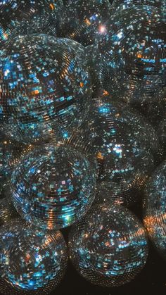 many shiny disco balls are stacked on top of each other