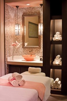 a spa room with towels on the bed