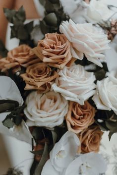 the bride's bouquet is made up of white and peach flowers