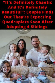 a man and two women are sitting on a bed with their babies in front of them