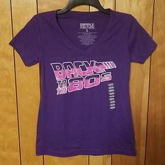 Womens Short Sleeve Graphic T Shirt Back To The 80s Vneck Cotton Polyester Blend Small Pit To Pit Across Roughly 17" Top Of Collar To Bottom Roughly 24" 90s Style Fitted Purple Top, Fitted 90s Style Purple Top, Fitted Purple Top In 90s Style, 90s Graphic Print Purple Top, 90s Purple Top With Graphic Print, 90s Style Purple Top With Graphic Print, Retro Purple Crew Neck Top, Purple V-neck Top With Graphic Print, Retro Purple Short Sleeve Top