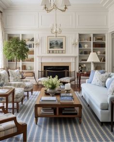 a living room filled with furniture and a fire place under a chandelier in front of a fireplace