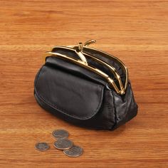 Classic Dual Clasp Leather Coin Purse complements any look, whether you're carrying it on its own or in your favorite handbag. Supple genuine leather purse features a dual goldtone metal clasp that opens to reveal two separate compartments for easy organizing, along with a snap-close exterior pocket perfect for tucking in a lipstick, coupons and more. Poly/PVC mini purse lining. Coin Bag measures 5 3/4" wide x 4 1/4" high. Wipe the coin pouch clean. Classic Gold Leather Coin Purse, Classic Gold Bifold Coin Purse, Formal Gold Coin Purse With Card Slots, Gold Bifold Coin Purse For Everyday Use, Gold Wallet With Coin Pocket For Everyday Use, Compact Gold Wallet For Everyday Use, Gold Wallets With Gold-tone Hardware For Everyday Use, Classic Gold Bifold Bag, Compact Gold Coin Purse With Card Slots