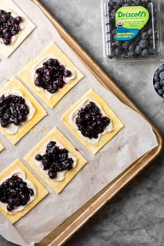 blueberry pies on a baking sheet with butter