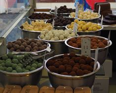 several bowls filled with different types of candies