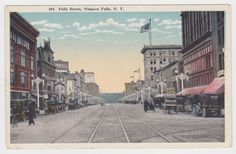 an old postcard shows people walking down the street