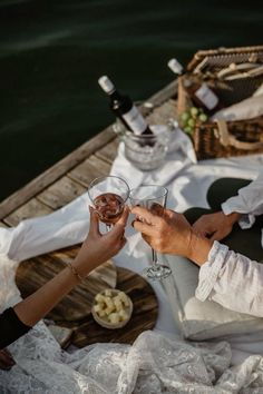 two people toasting with wine on a boat