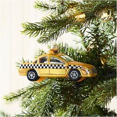 a taxi cab ornament hanging from a christmas tree